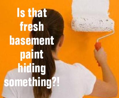 woman roller painting wall